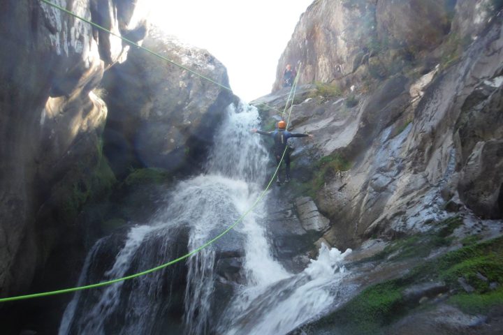 doing ziplining on a waterfall