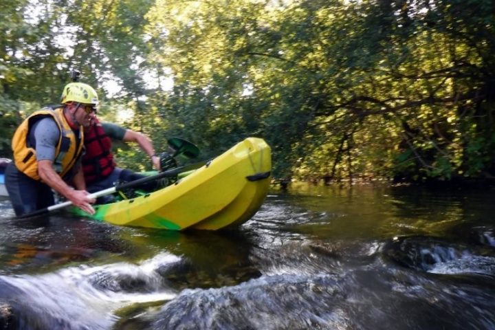 Men descending a river with canoe