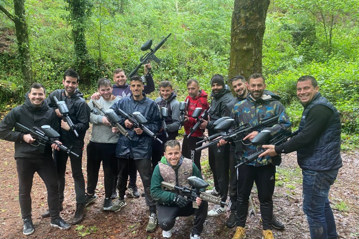 a group of people standing next to a tree