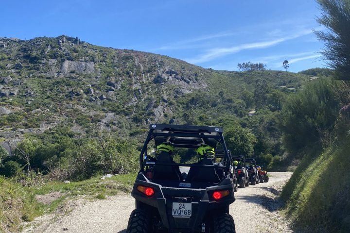 a motorcycle is parked on the side of a dirt road