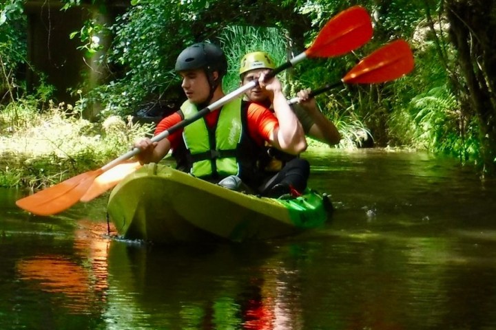 a man riding on a raft in a body of water
